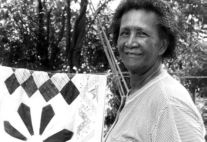 Mozell Benson with one of her quilts in her yard, Opelika, Alabama, courtesy National Endowment for the Arts